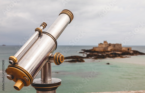 Tourist monocular telescope on the terrace of Saint Malo opposite the Fort National fortress