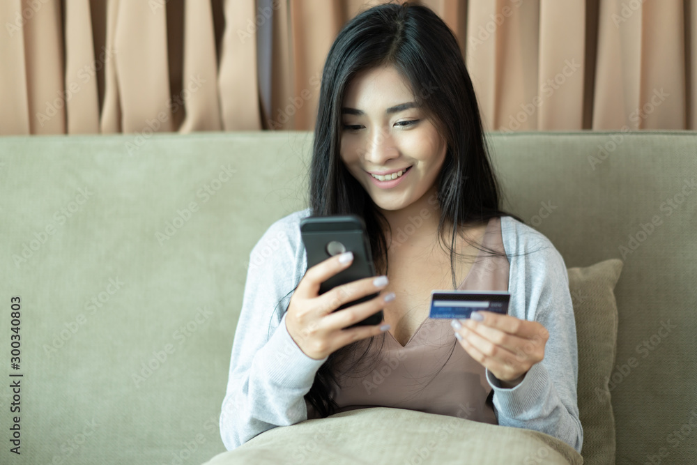 young woman Asian use credit card and phone young woman Asian use credit card and phone