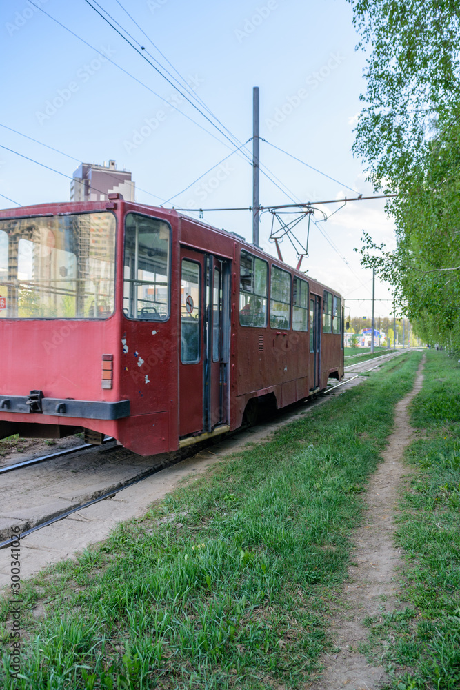 Kazan, Russia - May 9, 2019: A tram passes on a sunny spring day near the footpath. Electric and ecological transport.
