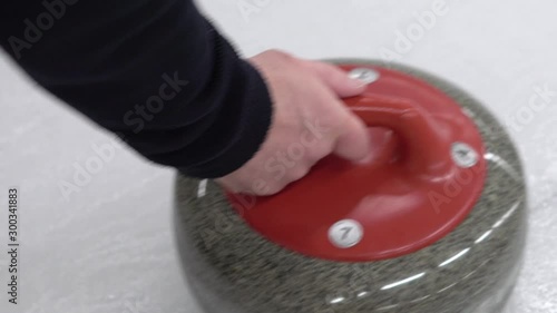 Curler is preparing to start a game. Winter team sport curling. Concept: how to play curling, winter olympic game, indoor games on ice