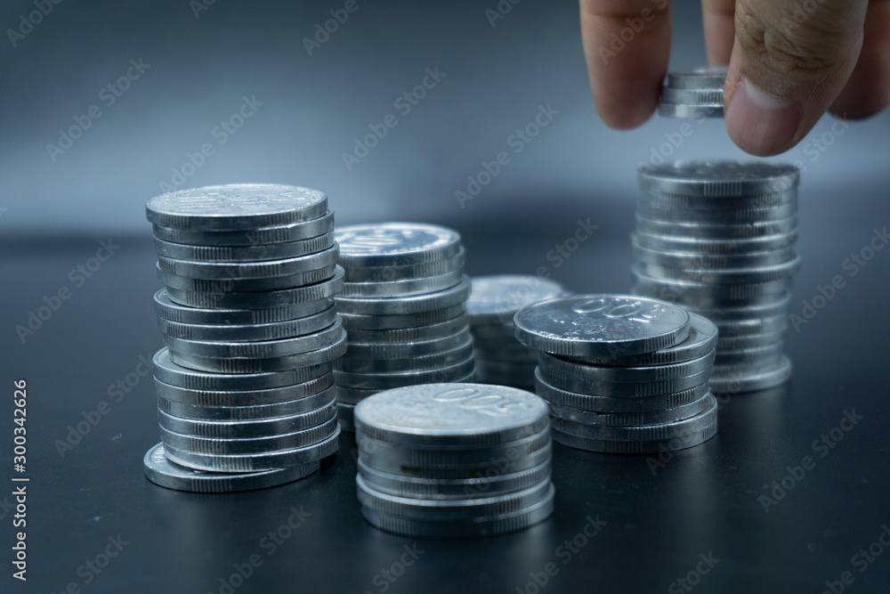 Close up of coins to stack of coins, Business Growth concept, There is money coins to stack of coins. Financial risk. Close up of coins to stack of coins, Business Growth concept, There is money coins to stack of coins. Financial risk.