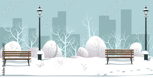 Winter park with street lamps and bushes covered with snow