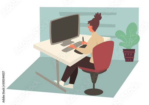 Woman working on computer in office and sitting behind desk