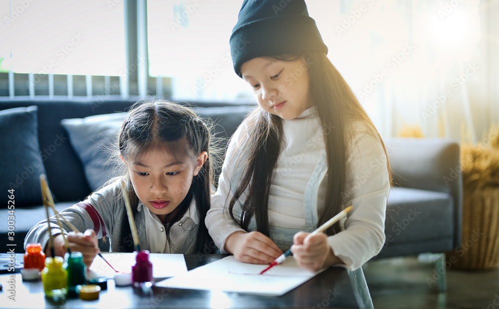 Asian family with cute kids painting art in living room at home Asian family with cute kids painting art in living room at home