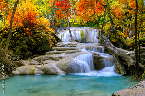 Colorful majestic waterfall in national park forest during autumn photo