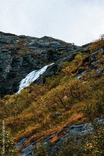 Norwegian Autumn powerful waterfall in the Forest