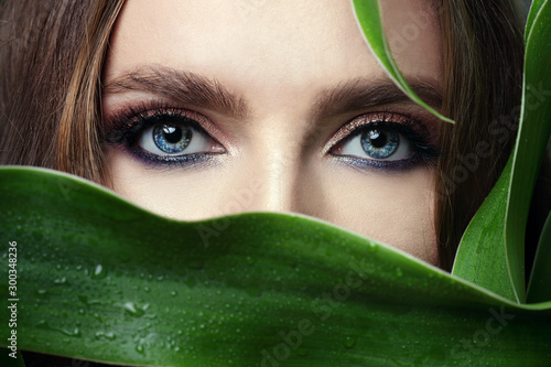 bright shiny eye makeup in glossy treatment. Elegant make-up. Blue eyes photo