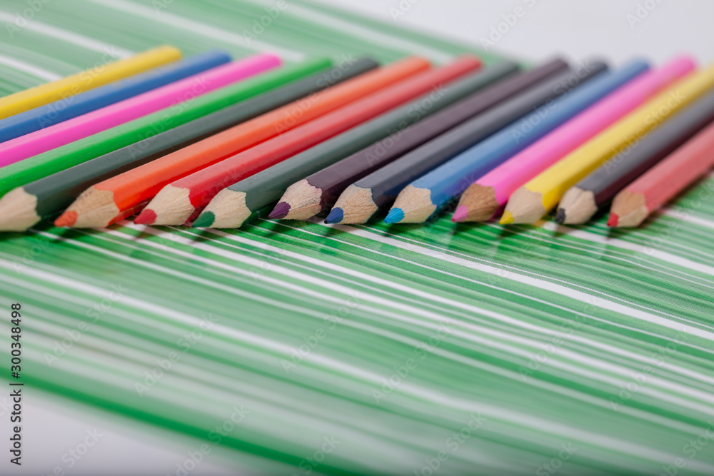 color pencils on a green background color pencils on a green background