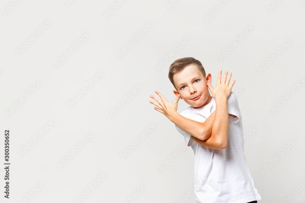 Carefree naughty caucasian boy grimaces. Portrait on an isolated background. Carefree naughty caucasian boy grimaces. Portrait on an isolated background.