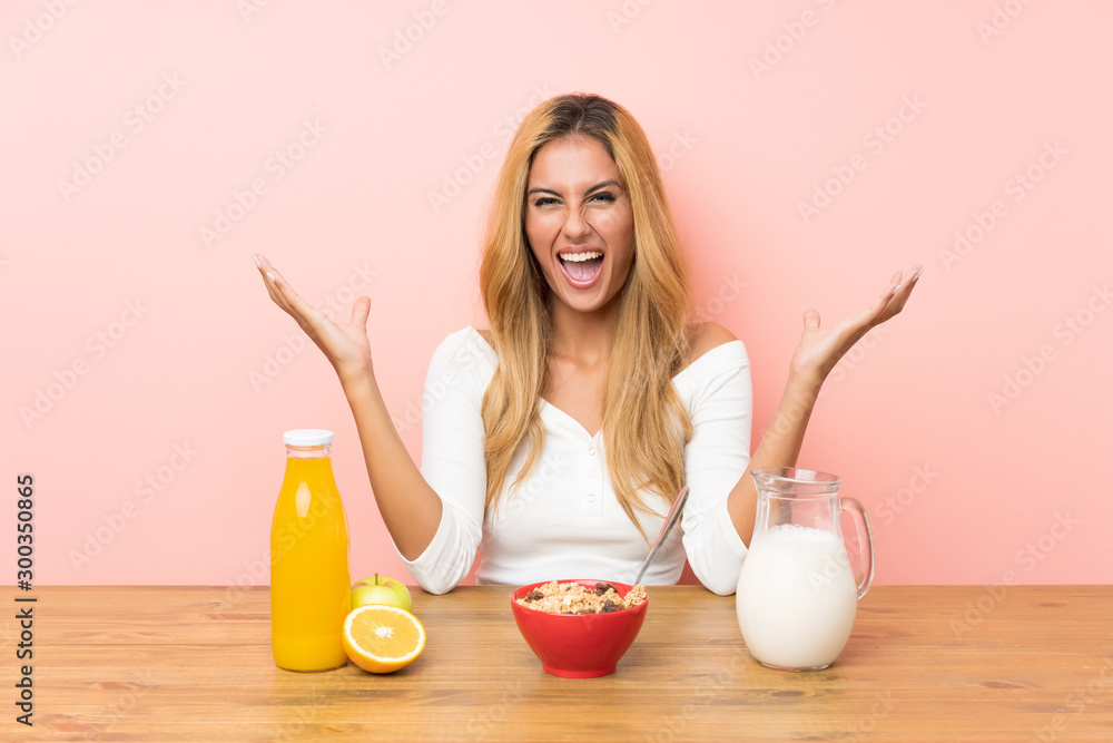 Young blonde woman having breakfast milk unhappy and frustrated with something Young blonde woman having breakfast milk unhappy and frustrated with something