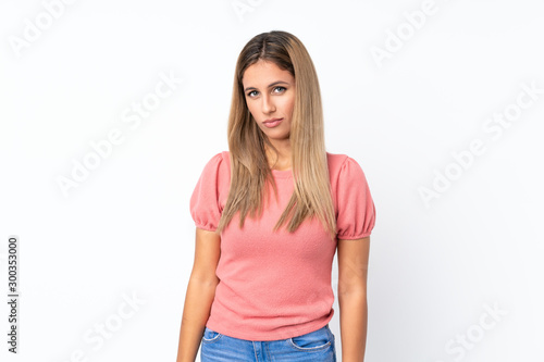 Young blonde woman over isolated white background with sad and depressed expression © luismolinero