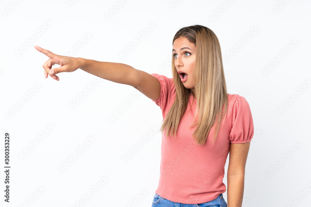 Young blonde woman over isolated white background pointing away Young blonde woman over isolated white background pointing away