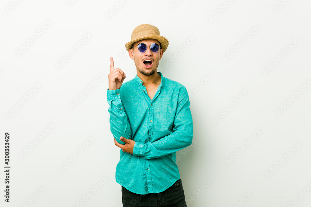 Young hispanic man wearing a summer clothes having some great idea, concept of creativity. Young hispanic man wearing a summer clothes having some great idea, concept of creativity.