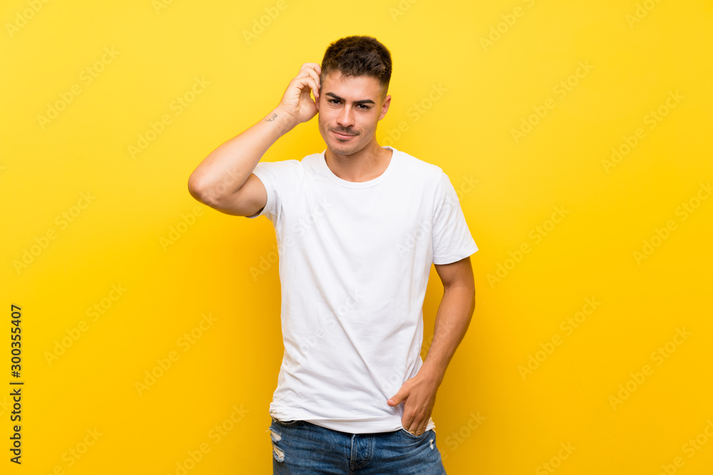 Young handsome man over isolated yellow background having doubts Young handsome man over isolated yellow background having doubts