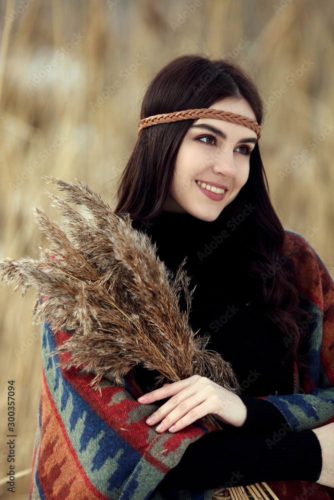 Close-up portrait of a girl in winter among cane. Close-up portrait of a girl in winter among cane.