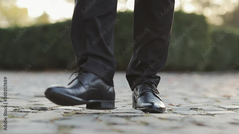 Closeup of luxury shoes, businessman walking, elegant rich person. Man in black shoes stepping forward Person moving forward outdoor. Closeup of luxury shoes, businessman walking, elegant rich person. Man in black shoes stepping forward Person moving forward outdoor.