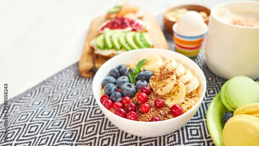 breakfast top view isolate white background. oatmeal with berries, toasts on a wooden tray, nuts, coffee breakfast top view isolate white background. oatmeal with berries, toasts on a wooden tray, nuts, coffee