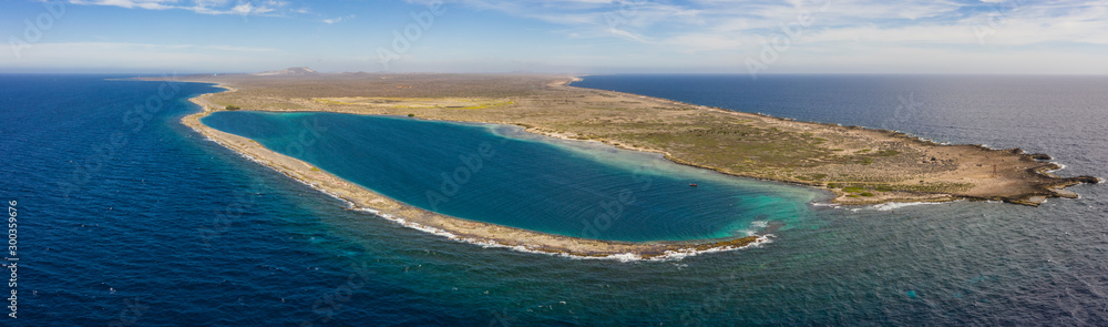 Aerial view of coast of Curaçao in the Caribbean Sea with turquoise water, cliff, beach and beautiful coral reef around Eastpiont