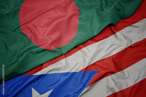 waving colorful flag of puerto rico and national flag of bangladesh.