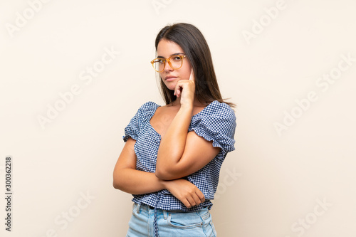 Young girl over isolated background with glasses