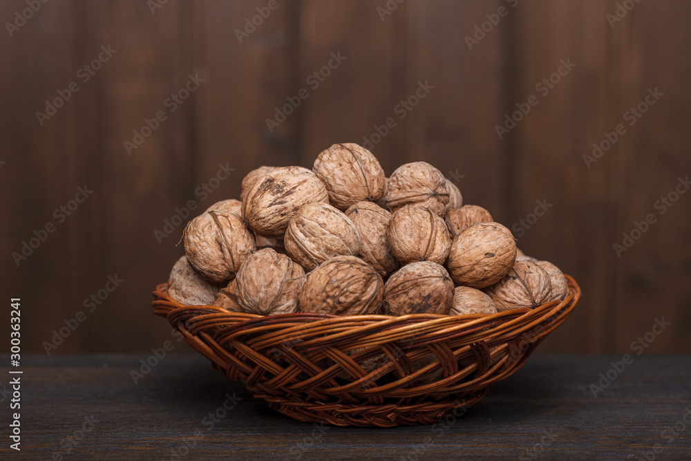 walnuts in a basket on a wooden table walnuts in a basket on a wooden table