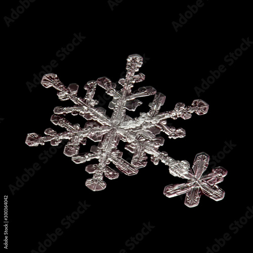 real snowflake on a black background