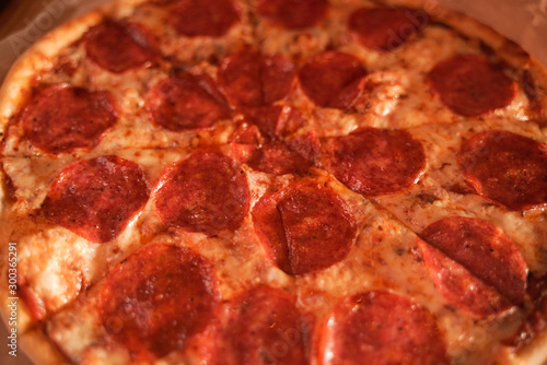 delicious fresh homemade pizza on the table. classic pepperoni pizza with sausage.
