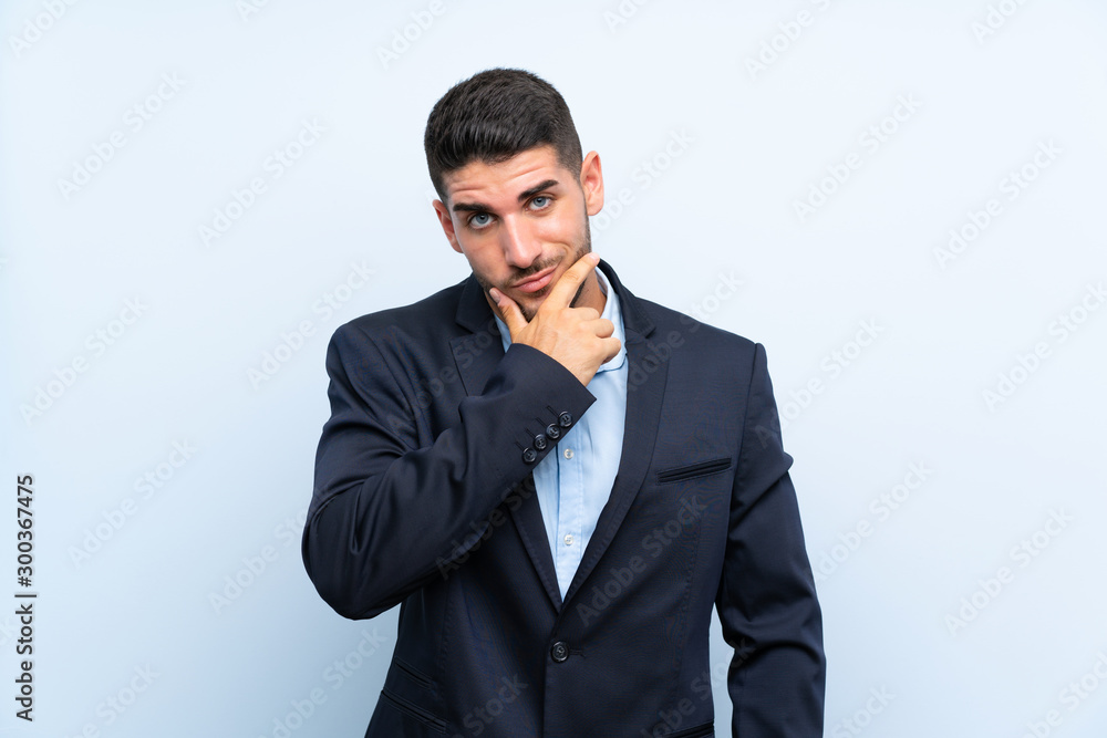 Handsome man over isolated blue background thinking Handsome man over isolated blue background thinking