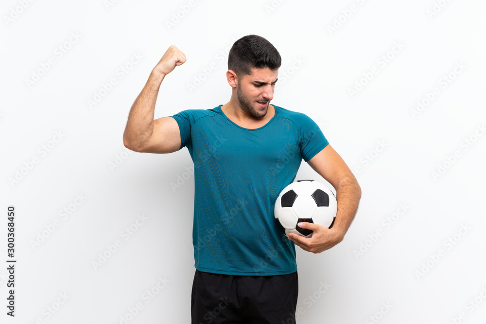 Handsome young football player man over isolated white wall celebrating a victory