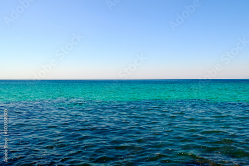 Beautiful seascape. Different colours of sea and sunset sky. Nautical background.