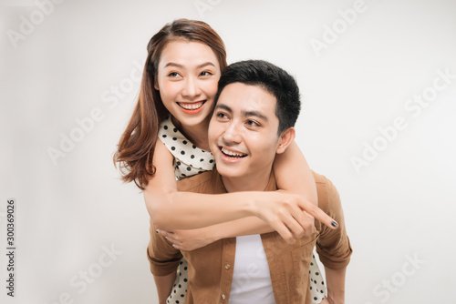 Image of lovely couple having fun while man piggybacking his girlfriend