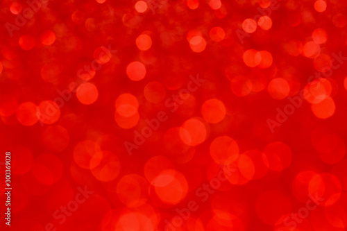 Abstract red bokeh background. Defocused christmas lights. Party, holiday and festive concept.