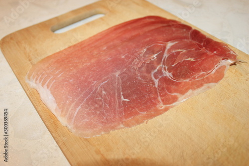 Pieces of pink meat lie on a cutting board