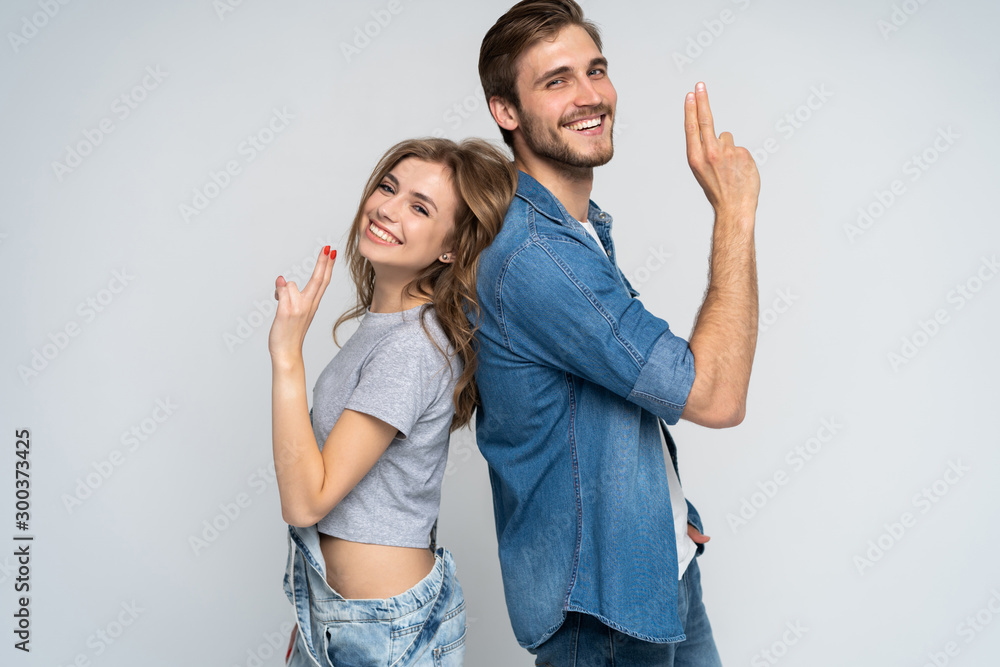 Fototapeta premium Portrait of happy couple isolated on white background. Attractive man and woman being playful.