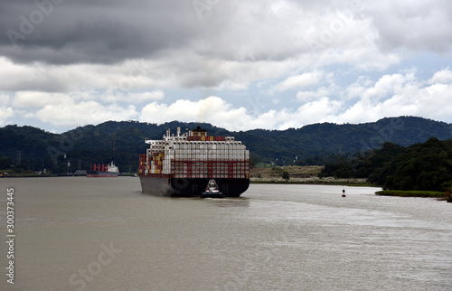 Panama canal landscape with container ship transiting from the Caribbean Sea to the Atlantic Ocean. 