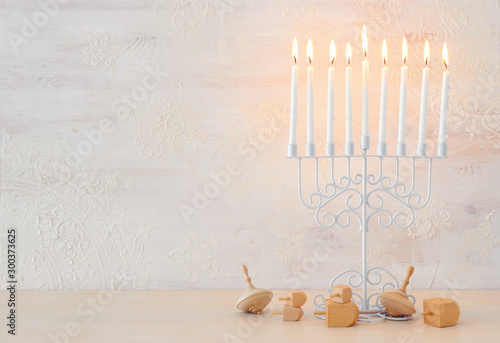 religion image of jewish holiday Hanukkah background with menorah (traditional candelabra)and spinning top over white background