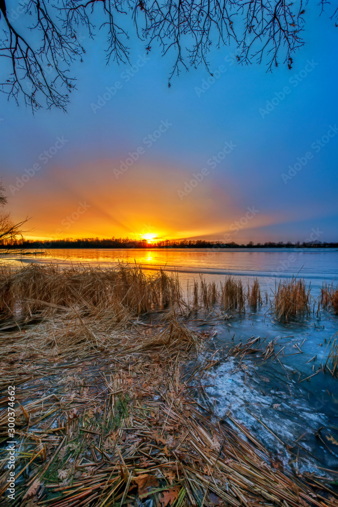 Vertical Image of Sunset over Lake in Winter