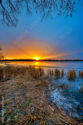 Vertical Image of Sunset over Lake in Winter © David Arment
