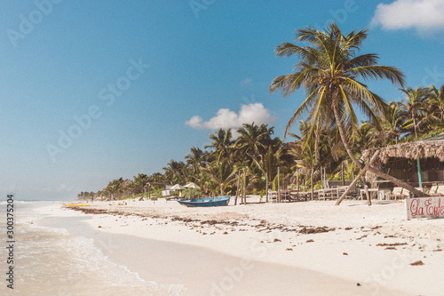 tropical beach with palm trees in Tulum Mexico © Lais