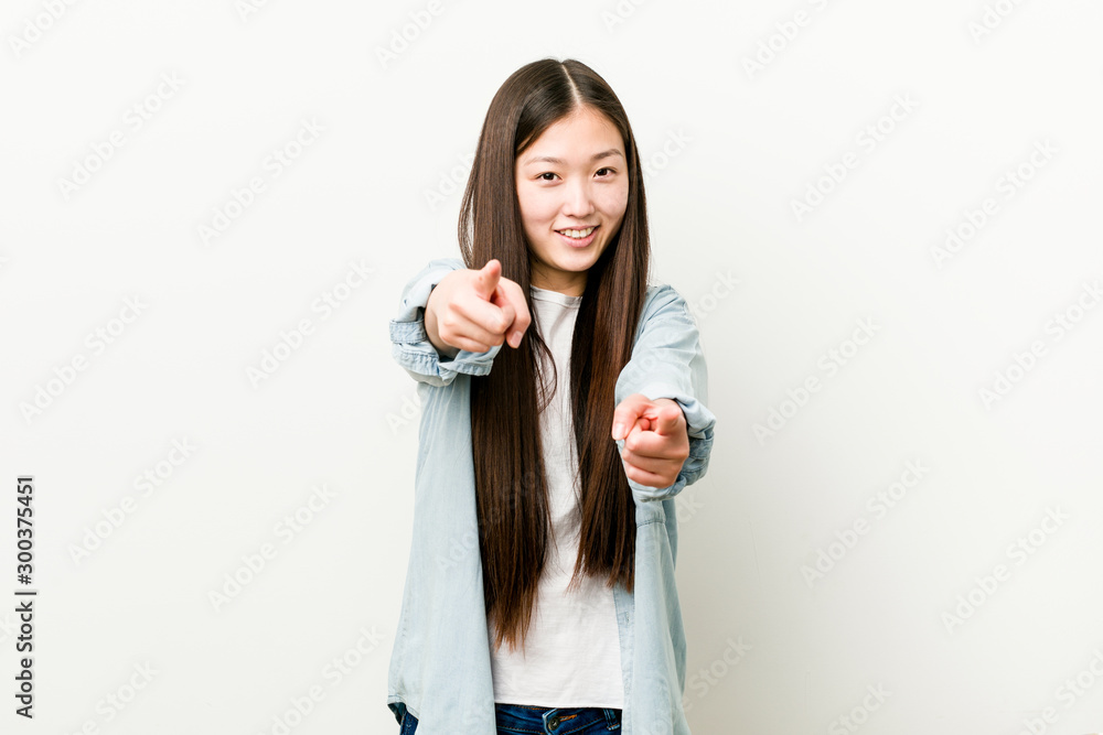 Young asian woman cheerful smiles pointing to front. Young asian woman cheerful smiles pointing to front.