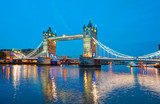 Panorama of the Tower Bridge and Tower of London on Thames river at twilight blue hour - London England