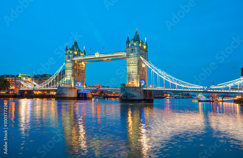 Panorama of the Tower Bridge and Tower of London on Thames river at twilight blue hour - London England