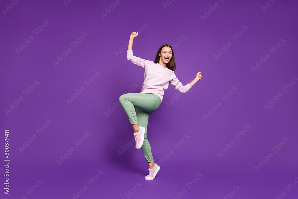 Full length body size turned photo of sweet charming cute girlfriend excited about having won ticket to local discotheque rejoicing isolated over purple vivid color background Full length body size turned photo of sweet charming cute girlfriend excited about having won ticket to local discotheque rejoicing isolated over purple vivid color background
