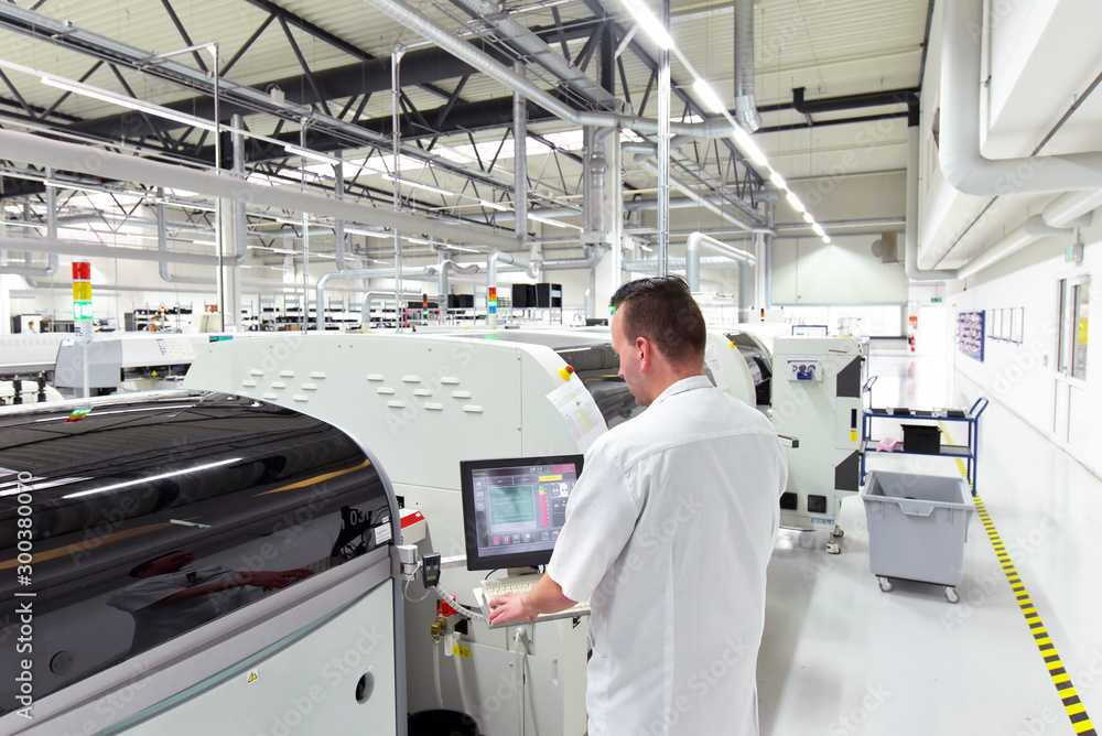 Obraz premium engineering in microelectronics: workers in the production and assembly of electronic high tech components in a modern factory