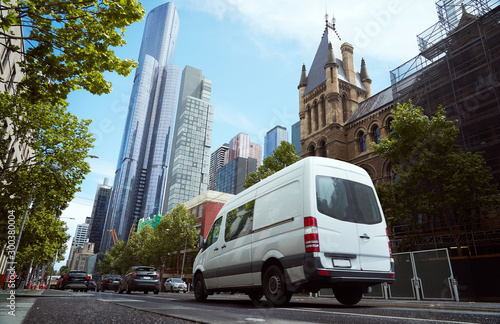 Fototapeta Naklejka Na Ścianę i Meble -  Delivery white van in the city street
