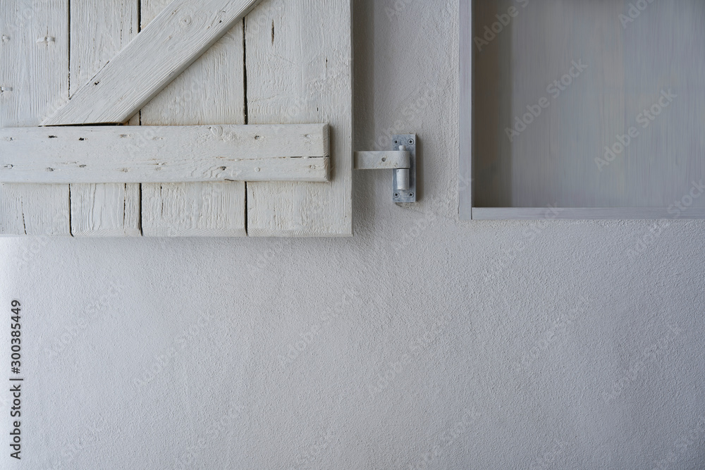 Empty shelf in white wall with wooden shabby white shutter - obrazy, fototapety, plakaty 