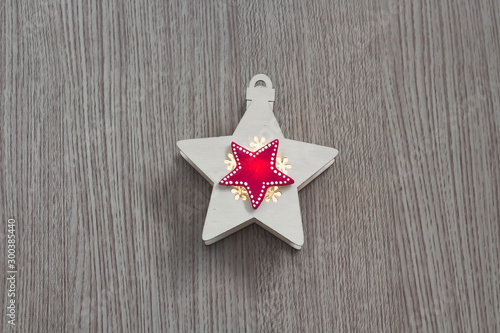 Red star over yellow star on a wooden background