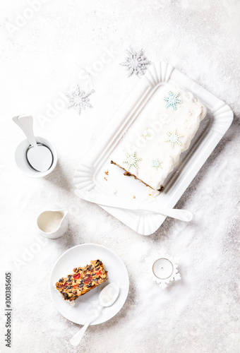 Christmas Fruit Cake, Pudding on snowy background . New Year pastries