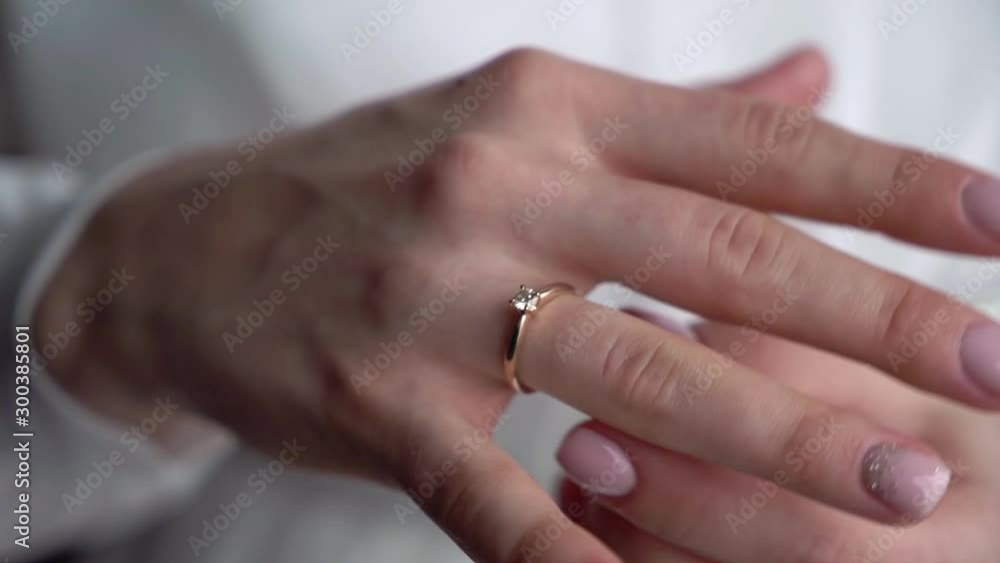 Young woman put on her finger jewelry ring with diamond. Luxury expensive proposal ring. Bride in wedding day. Young woman put on her finger jewelry ring with diamond. Luxury expensive proposal ring. Bride in wedding day.