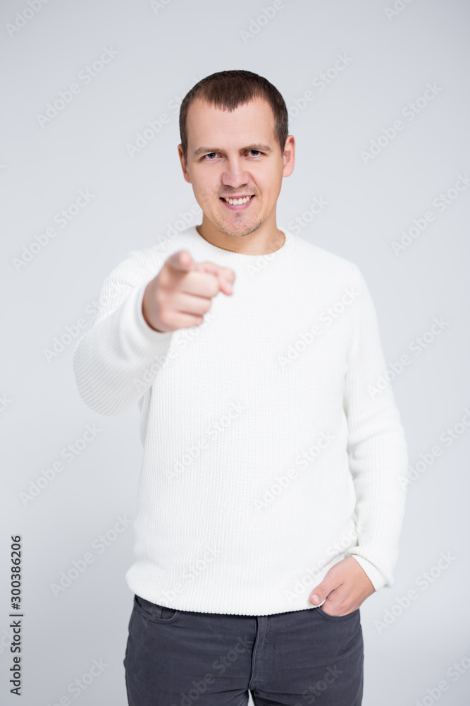 portrait of cheerful man pointing his finger at you portrait of cheerful man pointing his finger at you